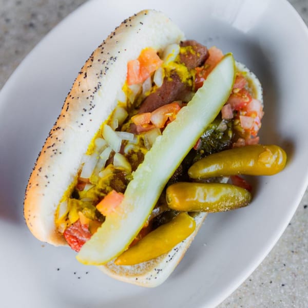 Sammy's Pub and Grill hot dog with mustard, relish, onions, tomatoes, and pickles.